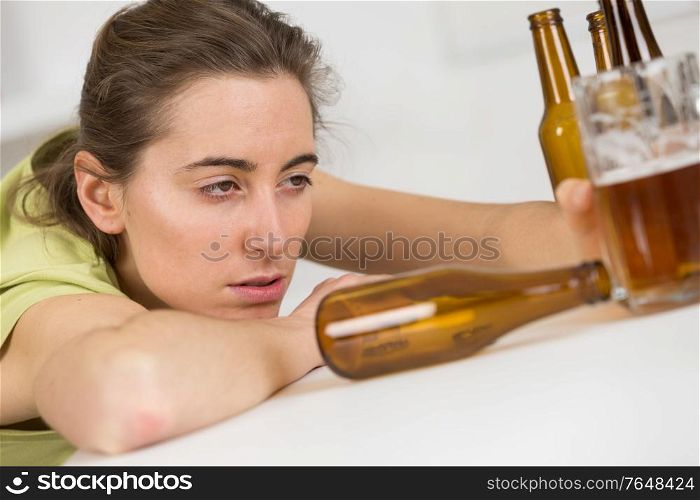 young drunk woman with bottles of beer