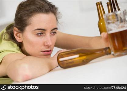 young drunk woman with bottles of beer