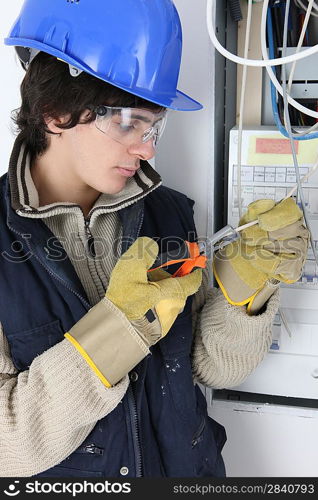 Young electrician stripping a wire