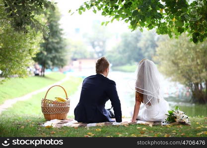 Young elegant enamoured just married bride and groom embracing