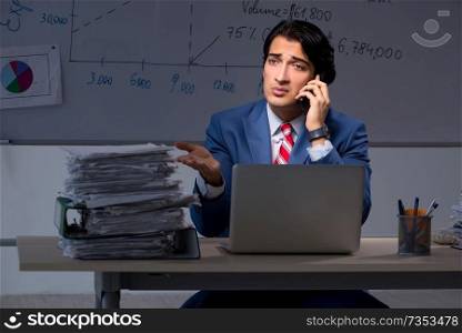 Young elegant financial specialist working in the office night time . Young elegant financial specialist working in the office night t