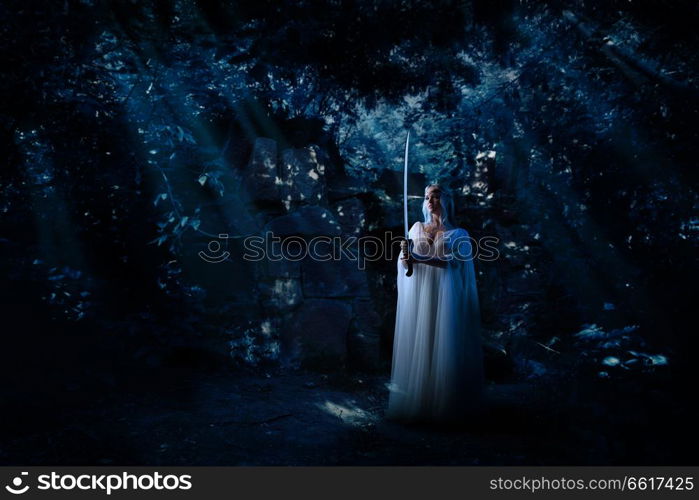 Young elf girl in night forest