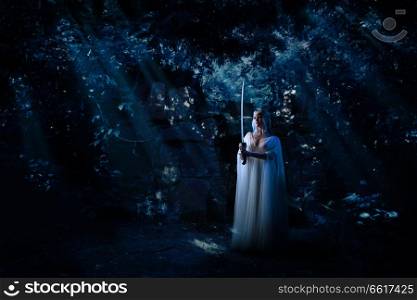 Young elf girl in night forest
