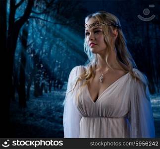 Young elven girl at night forest