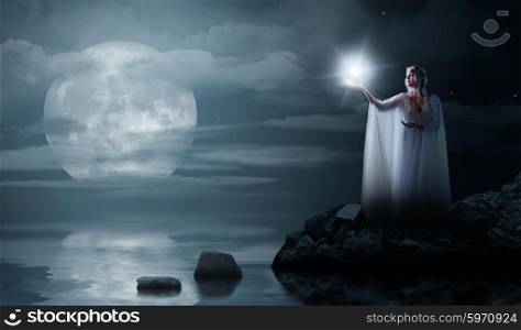 Young elven girl with star isolated on sea coast