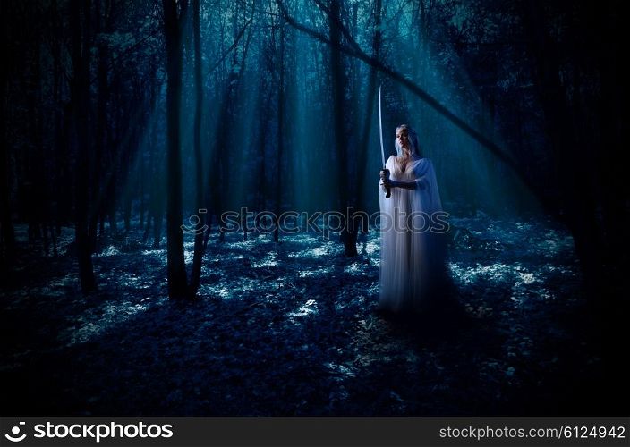 Young elven girl with sword at night forest