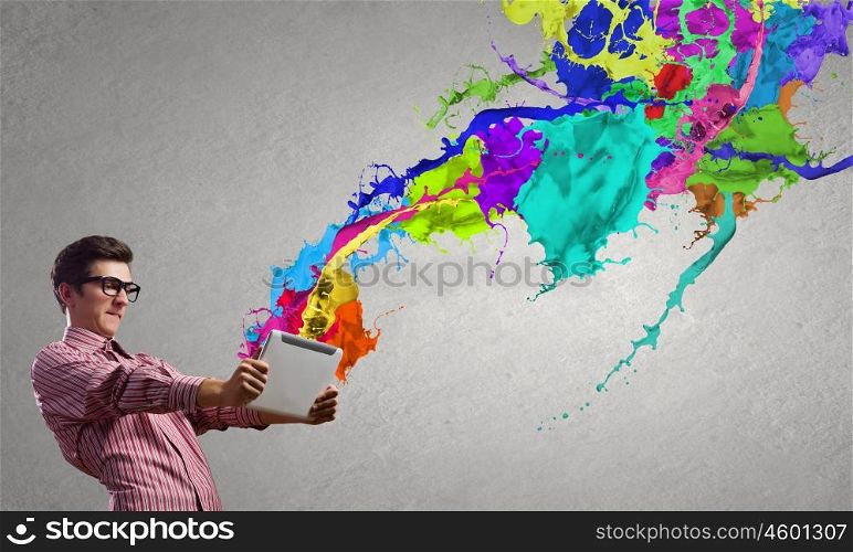 Young emotional businessman presenting tablet pc model. Evaluate color expression