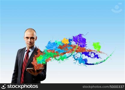 Young emotional businessman presenting tablet pc model. Evaluate color expression
