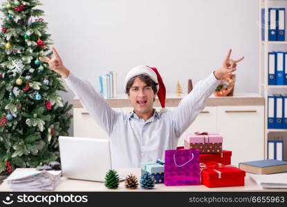 Young employee businessman in office christmas concept