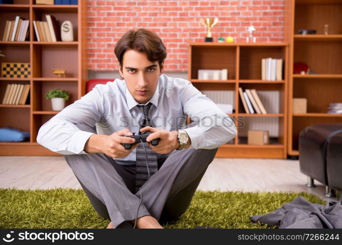 Young employee playing joystick games during his break 