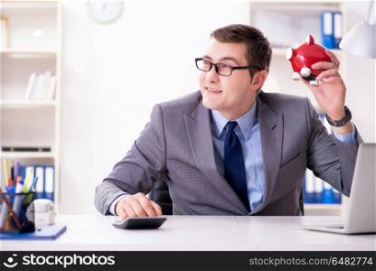 Young employee with piggybank in pension savings concept