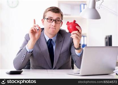 Young employee with piggybank in pension savings concept
