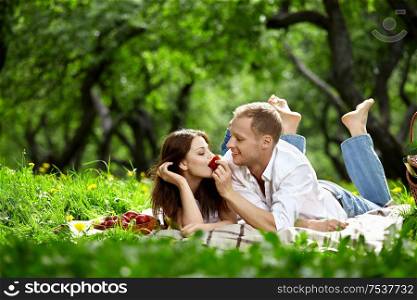 Young enamoured couple on picnic in wood