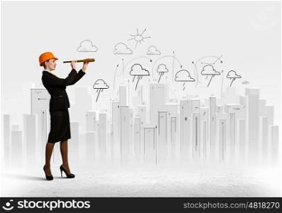 Young engineer. Image of young woman looking into tube. Construction concept