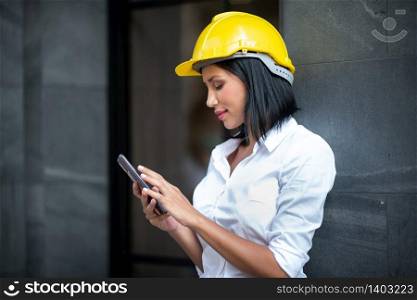 Young engineer wearing a helmet while inspecting work