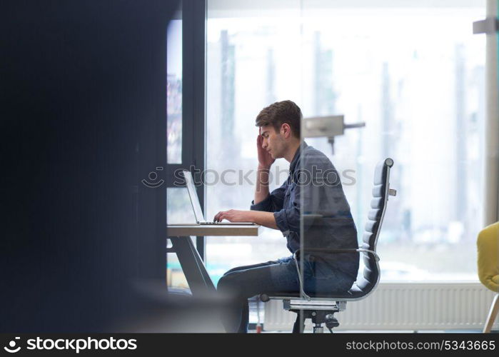 Young Entrepreneur Freelancer Working Using A Laptop In Coworking space