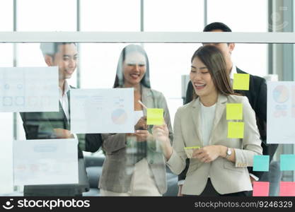 Young entrepreneurs in Asia Organize meetings to brainstorm and review information on glass board to get the best investment conclusion