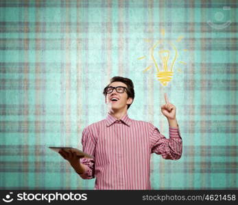 Young erudite. Young man in casual with book in hands