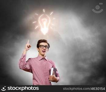 Young erudite. Young man in casual with book in hands