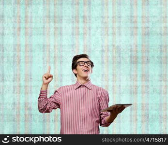 Young erudite. Young man in casual with book in hands