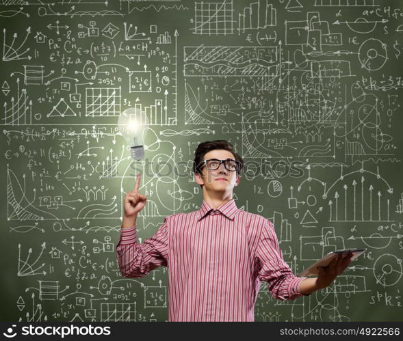 Young erudite. Young man in casual with book in hands