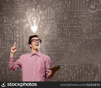 Young erudite. Young man in casual with book in hands