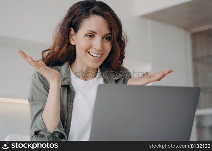 Young european woman has video call on laptop and have talk. Online meeting. Freelancer has corporate internet session. Girl staying home on quarantine. Remote work and communication.. Young woman has video call on laptop and have talk. Online meeting and remote communication.