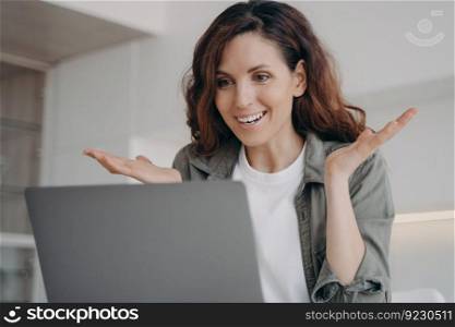 Young european woman has video call on laptop and have talk. Online meeting. Freelancer has corporate internet session. Girl staying home on quarantine. Remote work and communication.. Young woman has video call on laptop and have talk. Online meeting and remote communication.