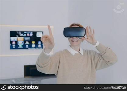 Young european woman in 3d goggles in office. Virtual reality design visualisation with VR headset. Exciting experience, contemporary education with vr glasses. Futuristic technology concept.. Young woman in 3d goggles in office. Futuristic technology and contemporary education.