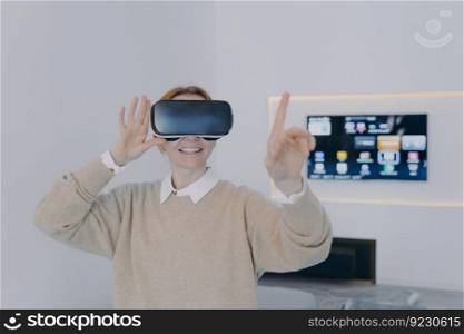 Young european woman in 3d goggles in office. Virtual reality design visualisation with VR headset. Exciting experience, contemporary education with vr glasses. Futuristic technology concept.. Young woman in 3d goggles in office. Futuristic technology and contemporary education.