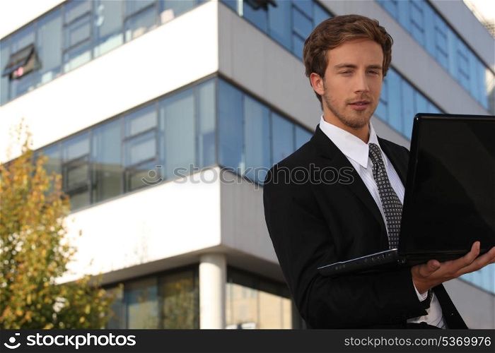 young executive in front of building