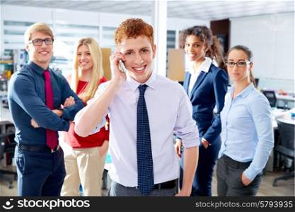 young executive talking phone in multi ethnic teamwork group as leader in office