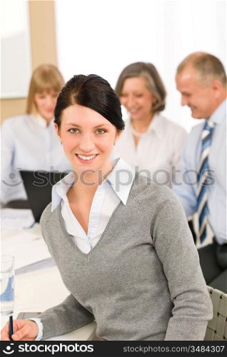 Young executive woman take notes during meeting with team colleagues
