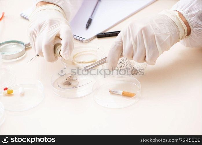 Young expert criminologist working in the lab 