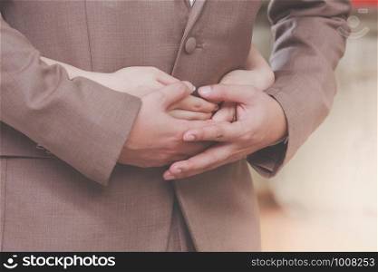 Young express love with a handshake as a symbol of love and marriage.