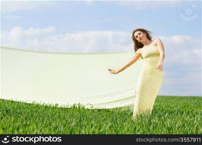 Young expressive cute woman in a green field