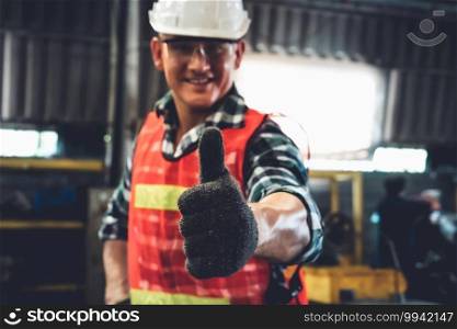Young factory job worker or engineer close up portrait in manufacturing factory . Industry and engineering concept .