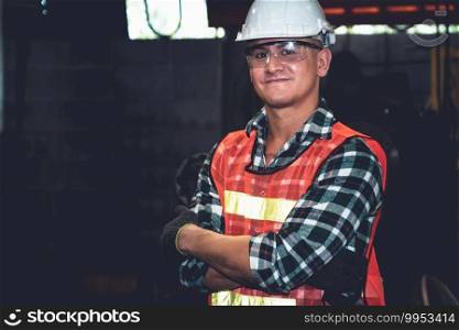 Young factory job worker or engineer close up portrait in manufacturing factory . Industry and engineering concept .