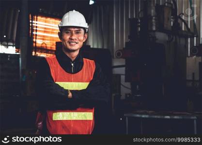 Young factory job worker or engineer close up portrait in manufacturing factory . Industry and engineering concept .. Young factory job worker or engineer close up portrait in manufacturing factory