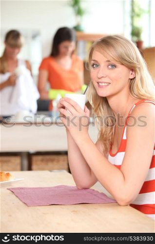 Young fair-haired woman having a tea