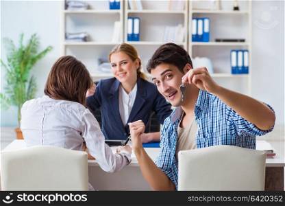 Young family agreeing mortgage contract in the bank for new house