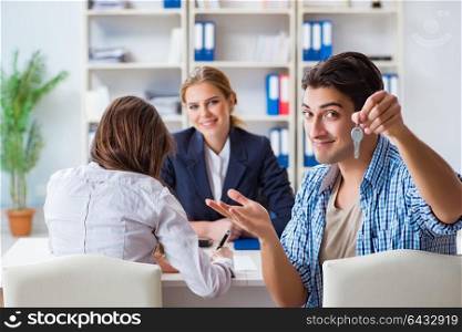 Young family agreeing mortgage contract in the bank for new house