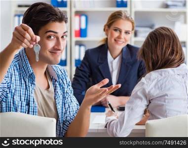Young family agreeing mortgage contract in the bank for new house. Young family agreeing mortgage contract in the bank for new hous