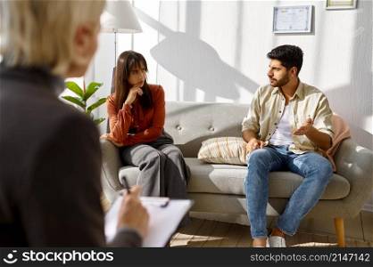 Young family at psychologist counseling meeting. Psychotherapy session. Couple psychological therapy. Young family couple at psychologist counseling meeting
