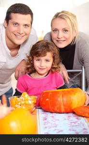 Young family carving pumpkins