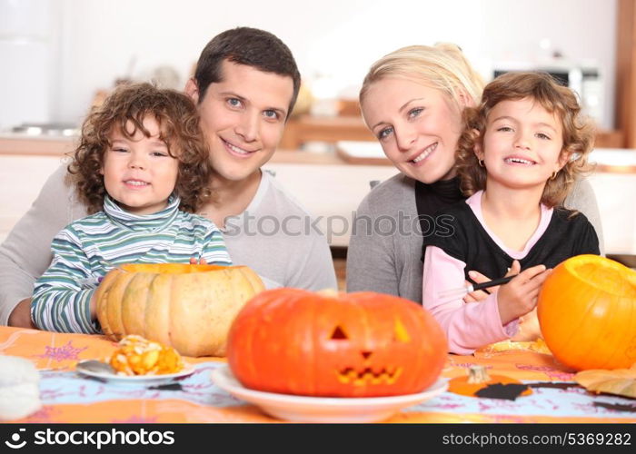 Young family carving pumpkins