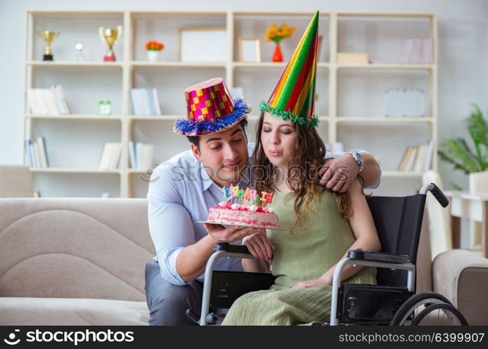 Young family celebrating birthday with disabled person