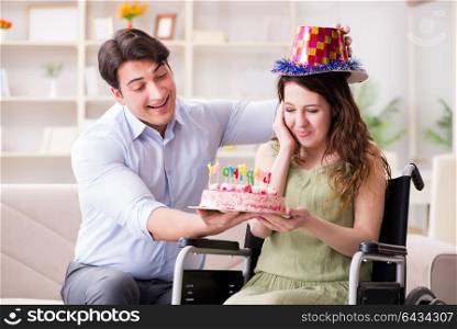 Young family celebrating birthday with disabled person