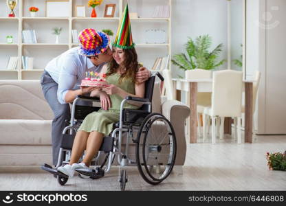 Young family celebrating birthday with disabled person