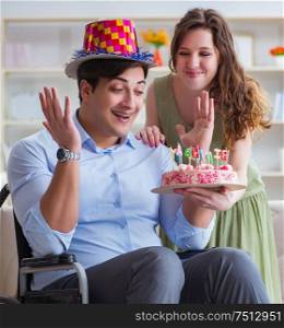 Young family celebrating birthday with disabled person. The young family celebrating birthday with disabled person